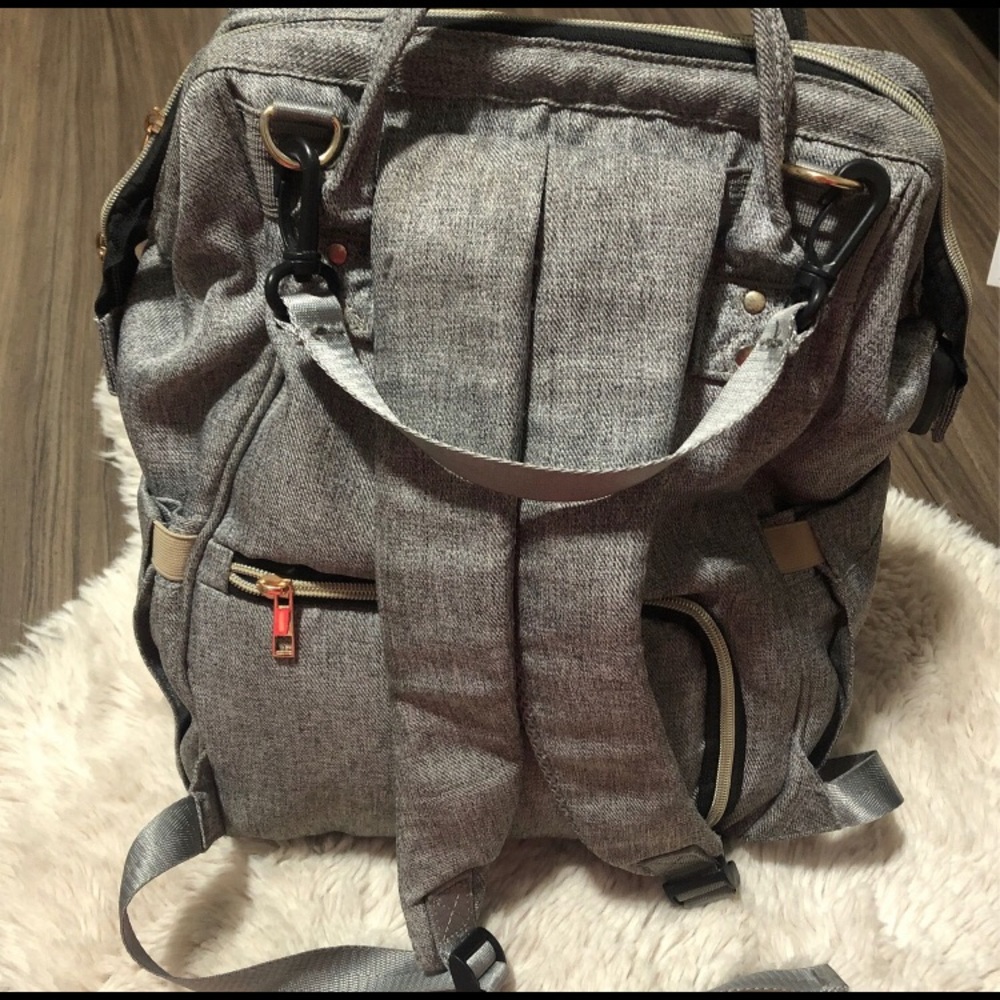 Diaper bag backpack has many compartments